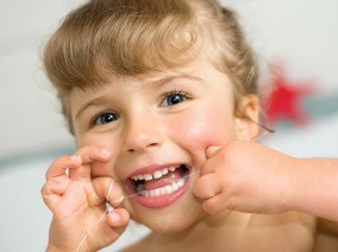 child flossing teeth Children's dentist near me